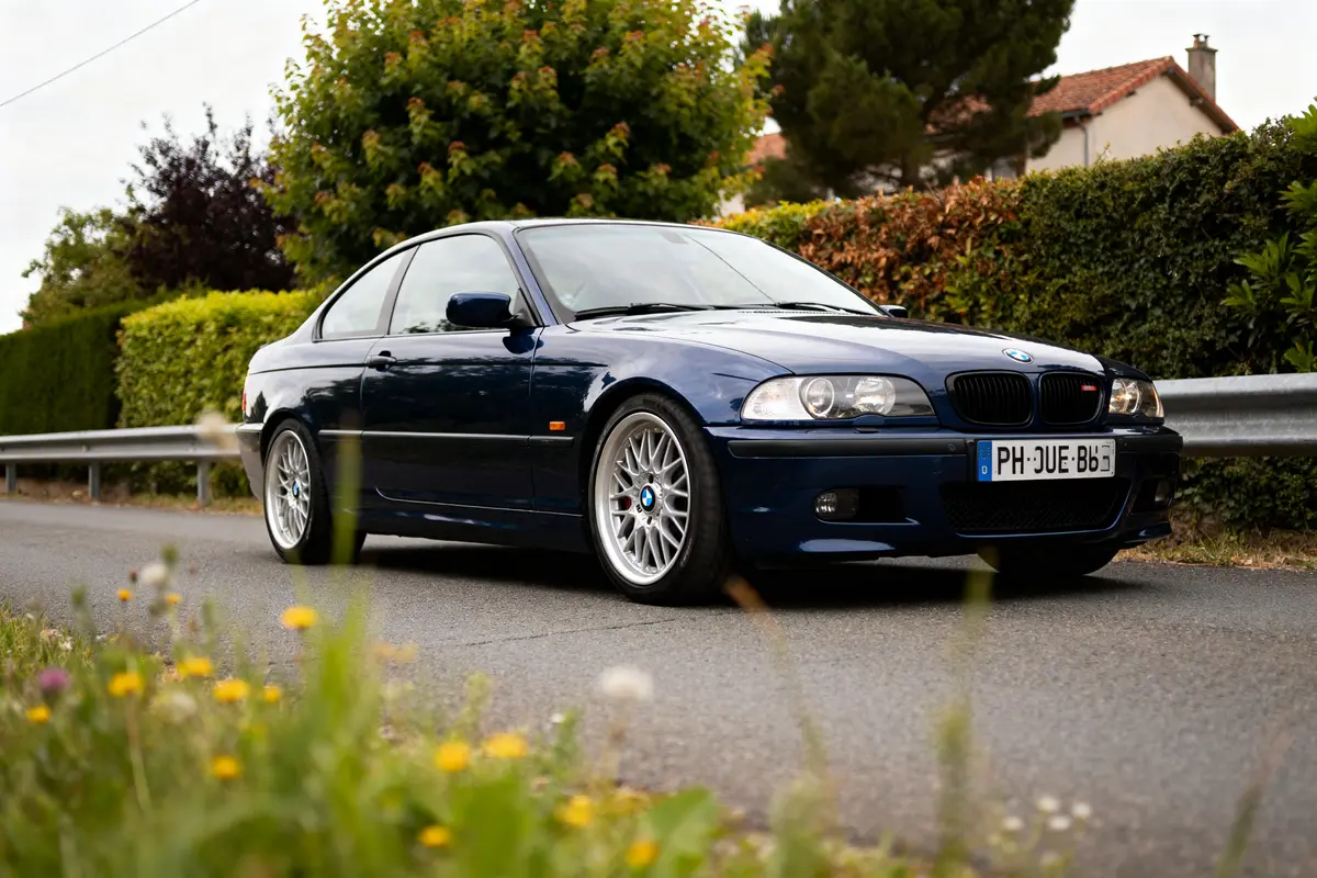 Voiture BMW E46 bleu foncé garée près des arbres en arrière-plan verdoyant